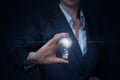 A businesswoman is holding a lightbulb with a digital brain model inside Royalty Free Stock Photo