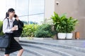 Businesswoman holding mobile phone & coffee outside office build Royalty Free Stock Photo