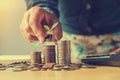 businesswoman holding money with plant growing on coins and putt Royalty Free Stock Photo