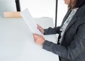 A businesswoman holding a papper in hand to apply of job concept in white office room