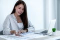 Businesswoman holding pen and analysis the chart with laptop at the office for setting challenging business goals And planning to