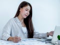 Businesswoman holding pen and analysis the chart with laptop at the office for setting challenging business goals And planning to