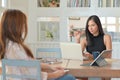 Businesswoman holding a pen pointing at the person sitting opposite She blamed the subordinate work