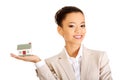 Businesswoman holding small house on palm. Royalty Free Stock Photo