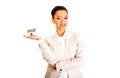 Businesswoman holding small house on palm. Royalty Free Stock Photo