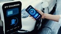 Smartphone display battery status interface by smart EV app. Peruse