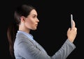 Businesswoman Holding Smartphone Using Face Recognition System Over Black Background Royalty Free Stock Photo