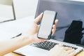 Businesswoman holding smartphone and using laptop Royalty Free Stock Photo