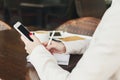 Businesswoman holding smartphone and writing notes closeup outdoors Royalty Free Stock Photo