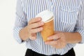 Businesswoman holding takeout coffee