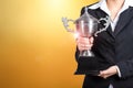 Businesswoman holding trophy award for success in business. gold Royalty Free Stock Photo