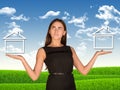 Businesswoman holding two houses as if chosing Royalty Free Stock Photo