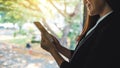 A businesswoman holding and using mobile phone indoors Royalty Free Stock Photo