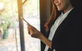 A businesswoman holding and using mobile phone indoors Royalty Free Stock Photo