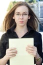 Businesswoman holds a yellow folder with paper