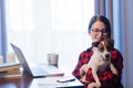 Businesswoman at home interior with dog