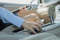 Businesswoman inside a car catch mobile phone for working