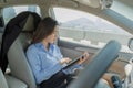Businesswoman inside a car using a tablet for working