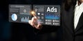 Businesswoman Interacting with Digital Marketing Dashboard Displaying Ads, Data Charts, and Analytics in Modern Office Royalty Free Stock Photo