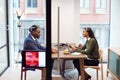 Businesswoman Interviewing Male Job Candidate In Meeting Room