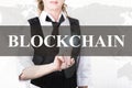 Businesswoman in a jacket and tie pressing blockchain button of a virtual screen. exchange and production of crypto Royalty Free Stock Photo