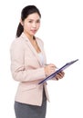 Businesswoman jot some note on clipboard