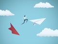 Businesswoman jumping between paper planes. Business symbol or metaphor for risk, danger, change, escape or bankruptcy