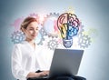 Businesswoman with laptop, gears and light bulb Royalty Free Stock Photo