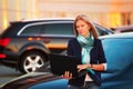 Fashion business woman using laptop on the car parking