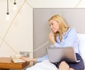 Businesswoman with laptop and phone in hotel room Royalty Free Stock Photo