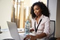 Businesswoman With Laptop Sitting At Desk Keeping Hydrated Drinking From Water Bottle In Office Royalty Free Stock Photo