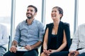 Businesswoman laugh and listen to fun presentation and seminar alongside with male business coworker Royalty Free Stock Photo