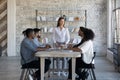 Businesswoman lead meeting with diverse colleagues in office Royalty Free Stock Photo