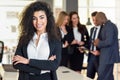 Businesswoman leader in modern office with businesspeople working at background Royalty Free Stock Photo