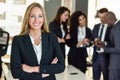 Businesswoman leader in modern office with businesspeople working at background Royalty Free Stock Photo