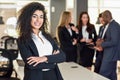 Businesswoman leader in modern office with businesspeople working at background Royalty Free Stock Photo