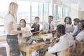 Businesswoman Leads Meeting Around Table Shot Through Door Royalty Free Stock Photo