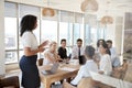 Businesswoman Leads Meeting Around Table Shot Through Door Royalty Free Stock Photo