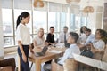 Businesswoman Leads Meeting Around Table Shot Through Door Royalty Free Stock Photo