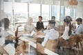 Businesswoman Leads Meeting Around Table Shot Through Door Royalty Free Stock Photo