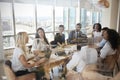 Businesswoman Leads Meeting Around Table Shot Through Door Royalty Free Stock Photo