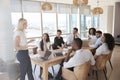 Businesswoman Leads Meeting Around Table Shot Through Door Royalty Free Stock Photo