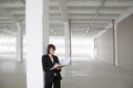 Businesswoman Leaning Against Pillar With Paperwork Royalty Free Stock Photo