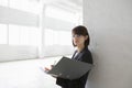 Businesswoman Leaning Against Wall With Paperwork Royalty Free Stock Photo