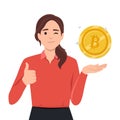 Businesswoman leaning to big bitcoin and showing thumb up gesture. Electronic currency concept