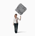 Businesswoman lifting heavy rock