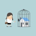 Businesswoman with locked house inside the cage, home foreclosure.