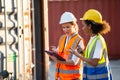 Businesswoman and logistics woman worker checking containers box and loading products in computer from Cargo freight ship at