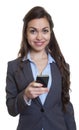 Businesswoman with long brown hair writing message with phone Royalty Free Stock Photo