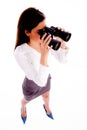 Businesswoman looking through binocular